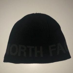 Gray reversible North Face hat.